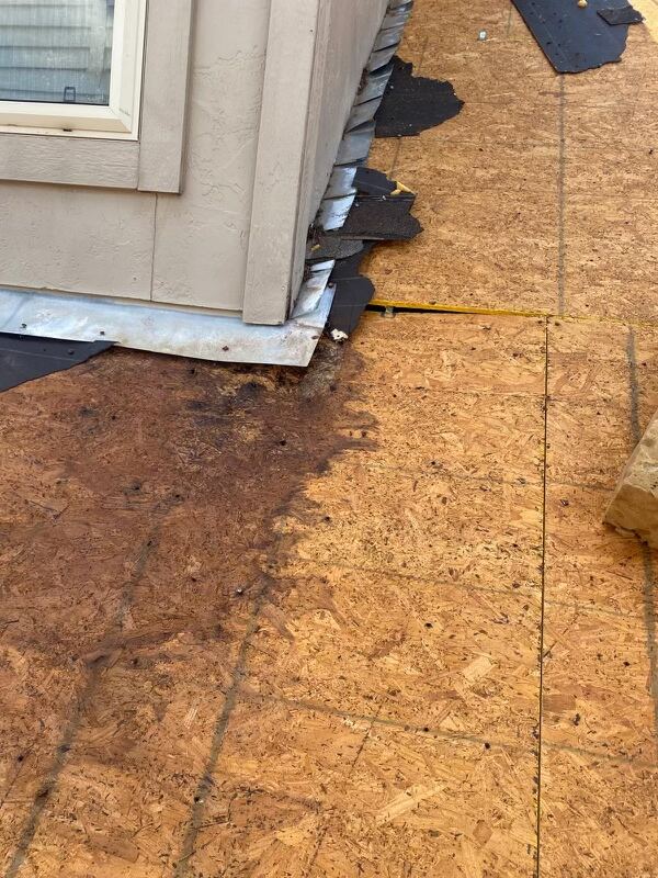 New flashing detail at corner of stucco wall and roof line — clean metal edge.